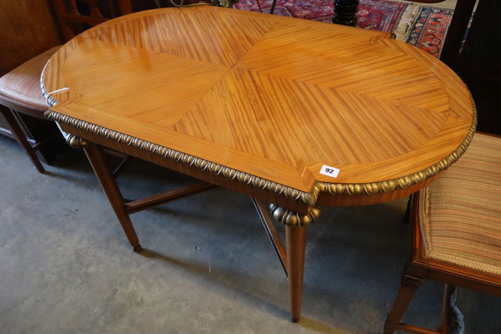 A parcel gilt satinwood centre table, width 113cm height 62cm, and a pair of Edwardian satinwood salon chairs